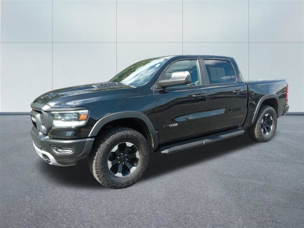 2021 RAM 1500 Rebel in Diamond Black Cry — front three-quarter view
