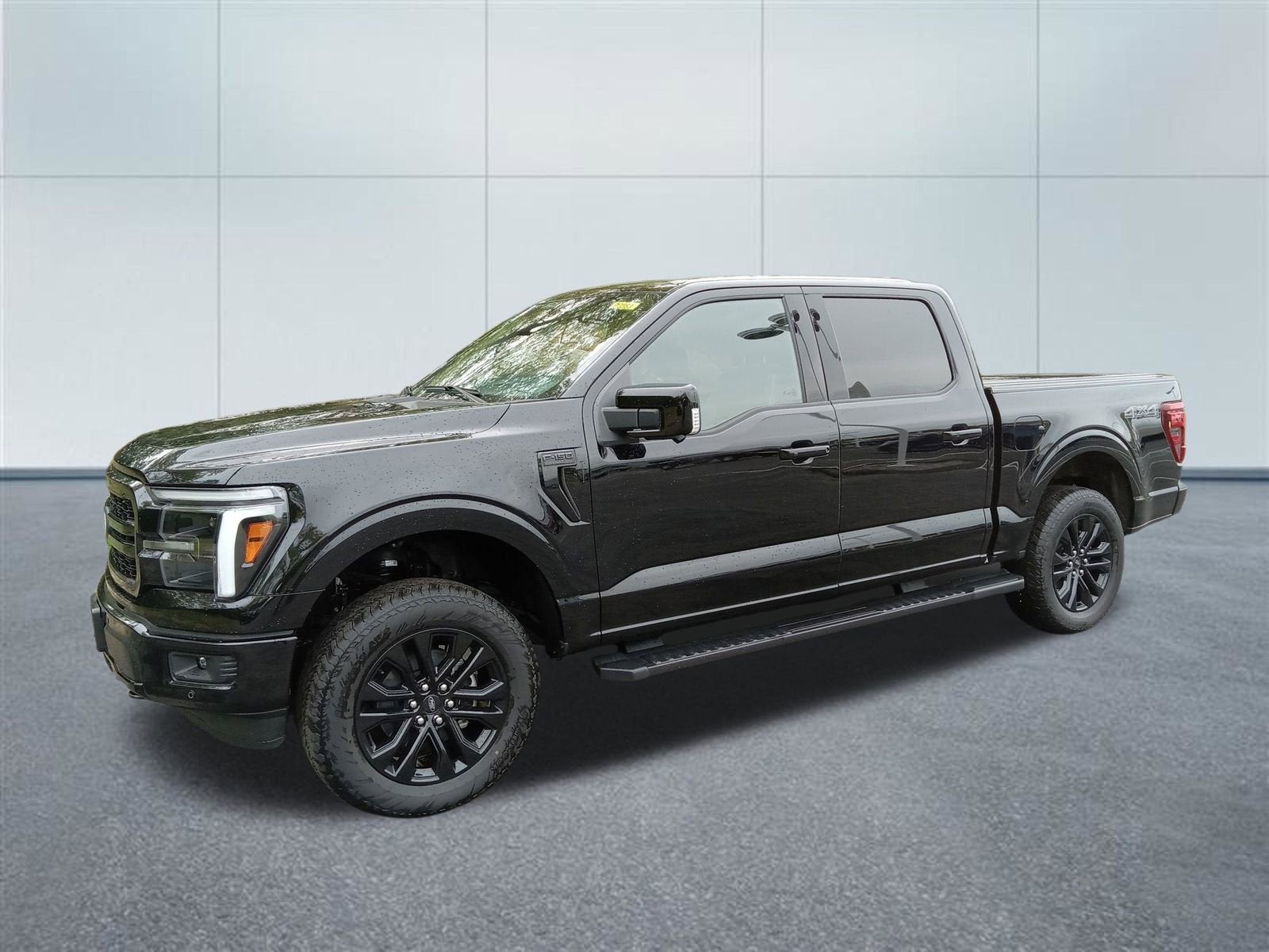 2025 Ford F-150 LARIAT in Agate Black Met — front three-quarter view